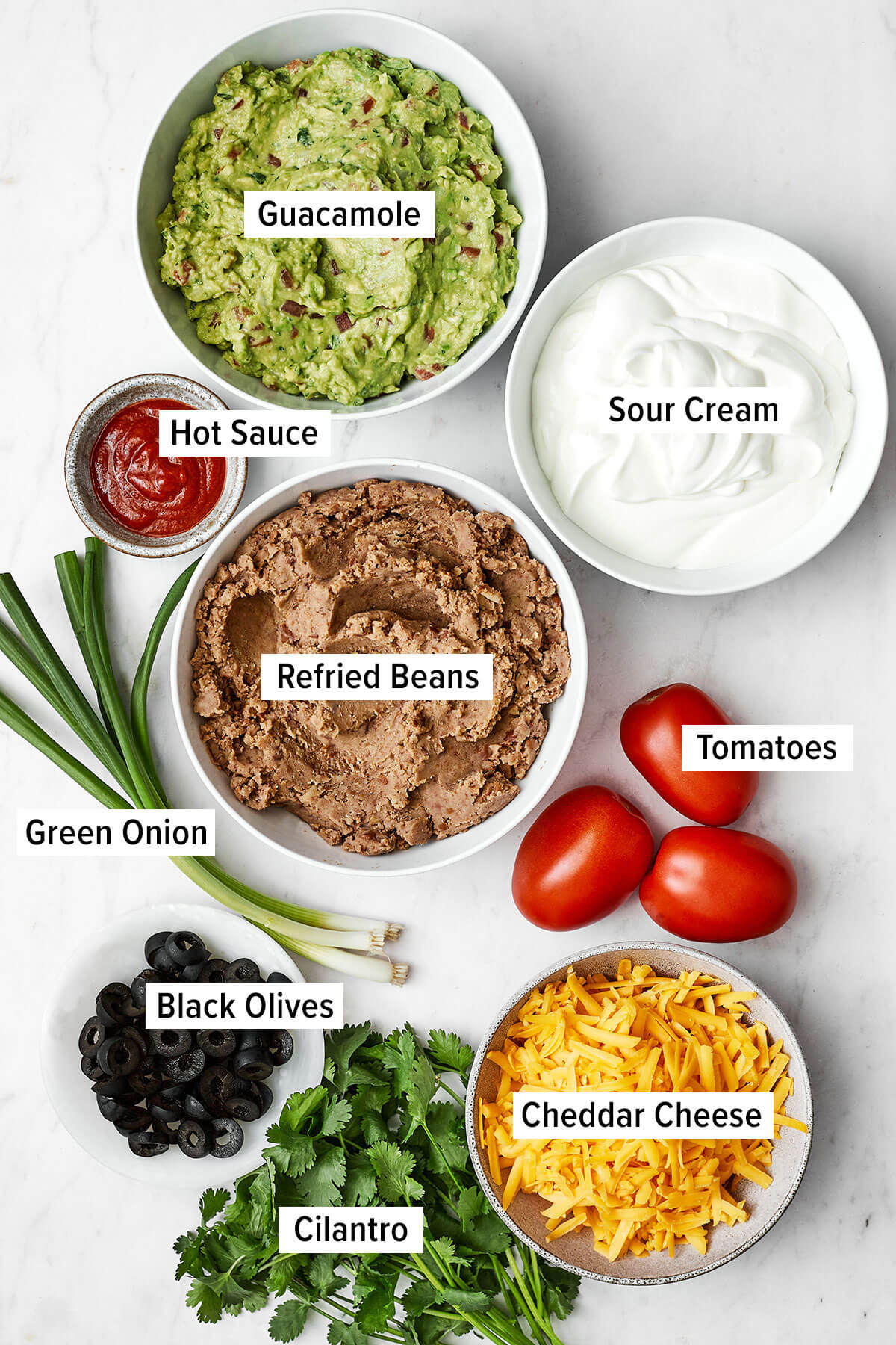 Ingredients for 7 layer dip on a table