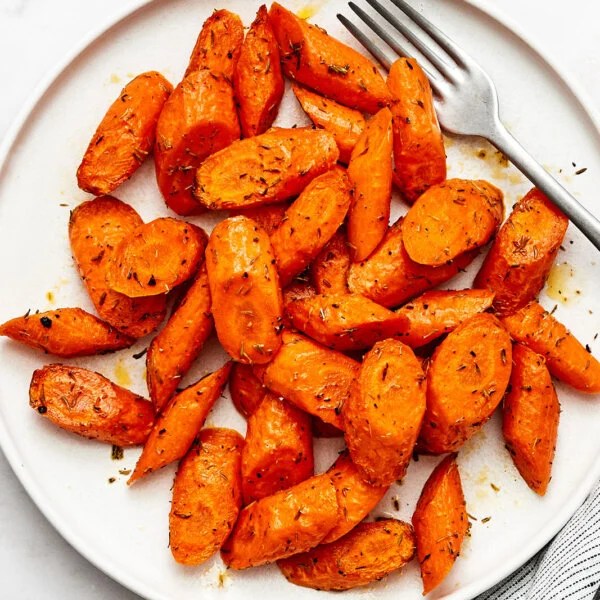 A plate of air fryer carrots and a fork