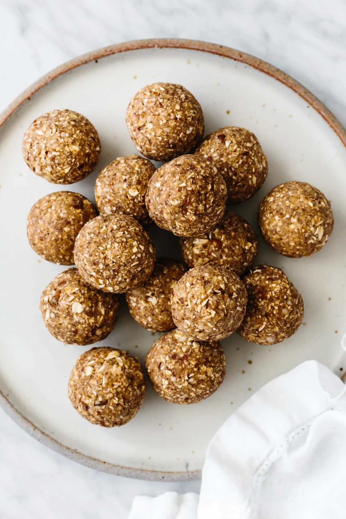 A stack of energy balls on a white plate.