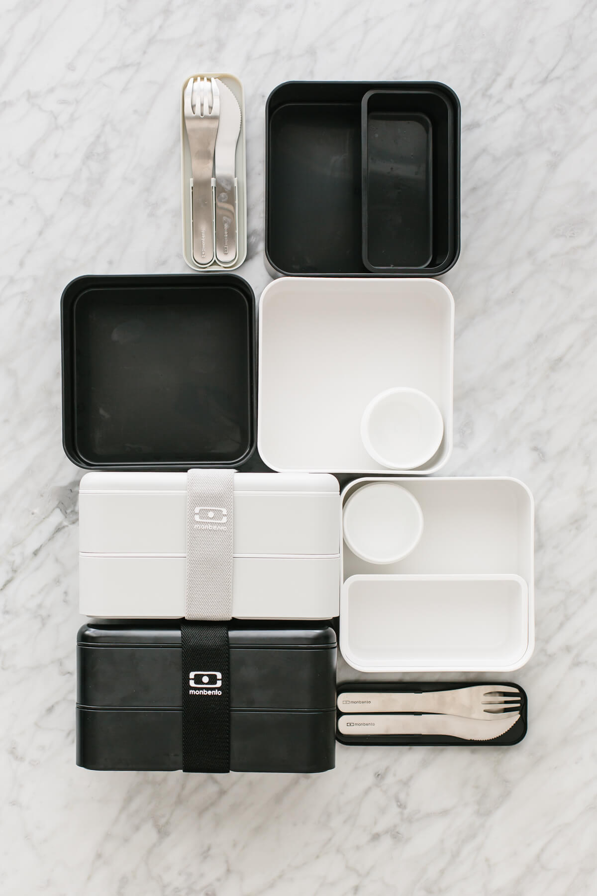 A bunch of empty bento box containers on a countertop.