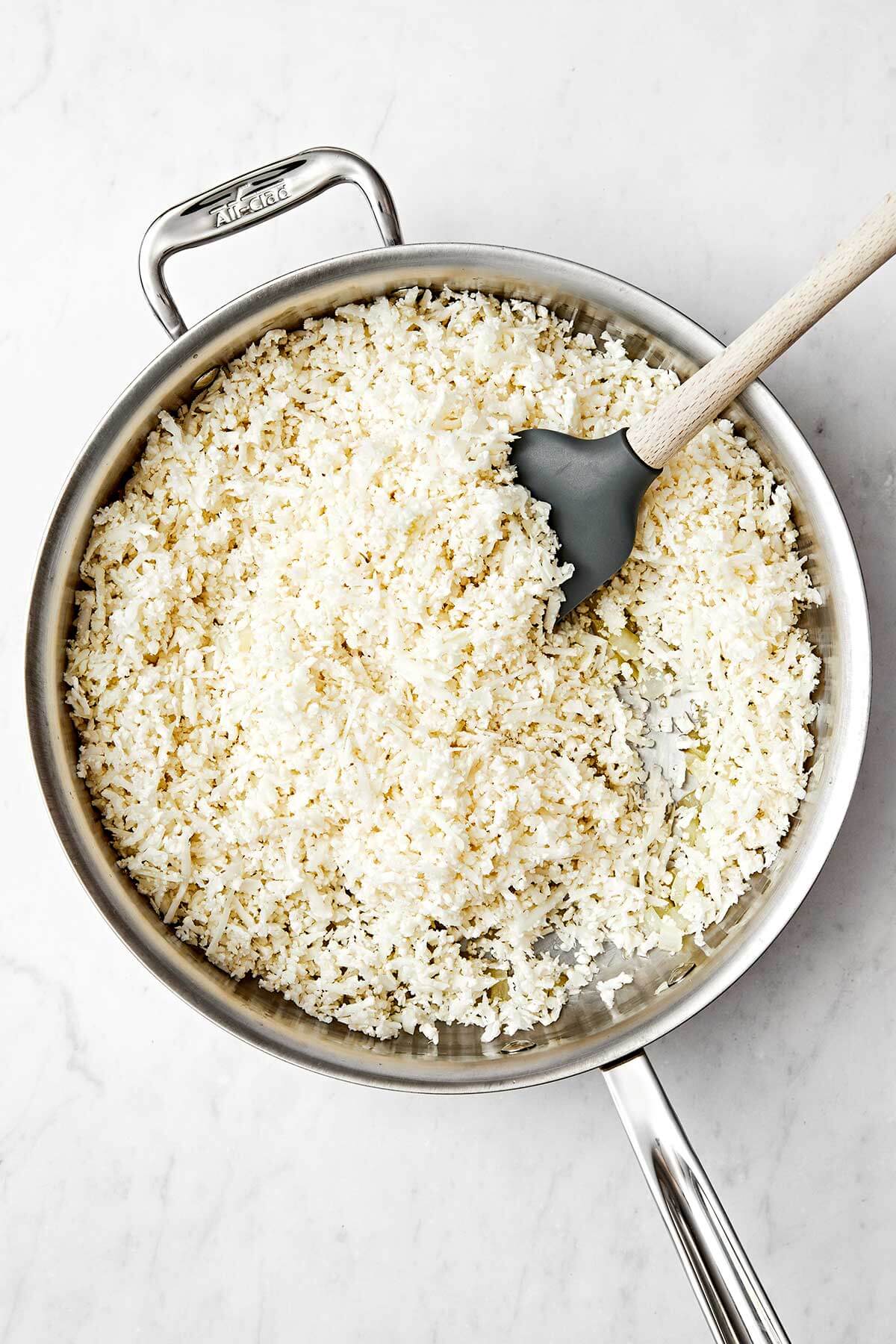 Cooking cauliflower rice in a pan.