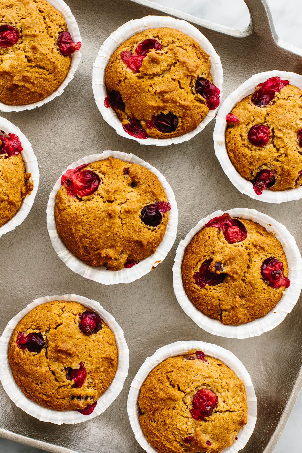 A tray filled with cranberry orange muffins