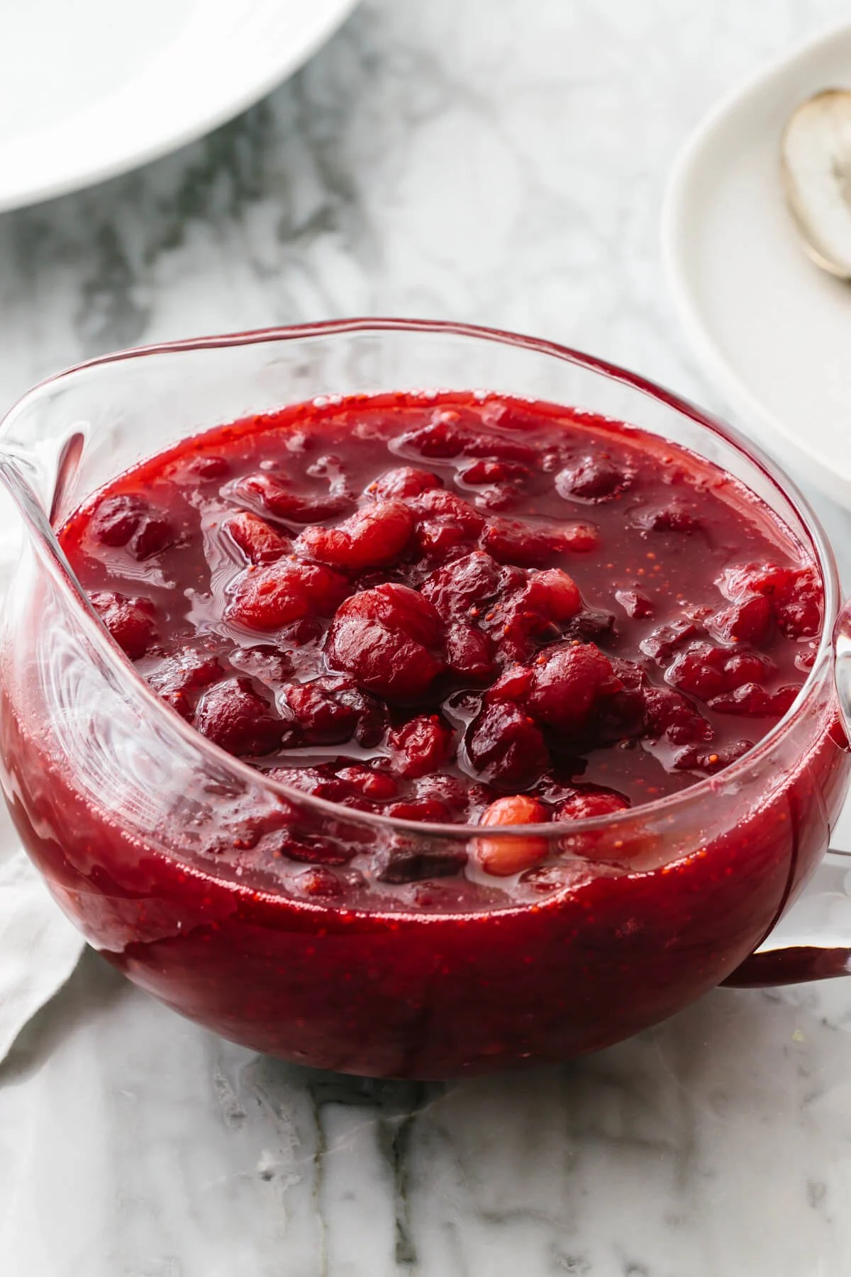 Homemade cranberry sauce in a glass bowl.