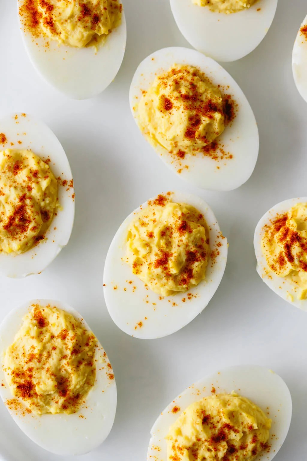 Deviled eggs on a white plate.