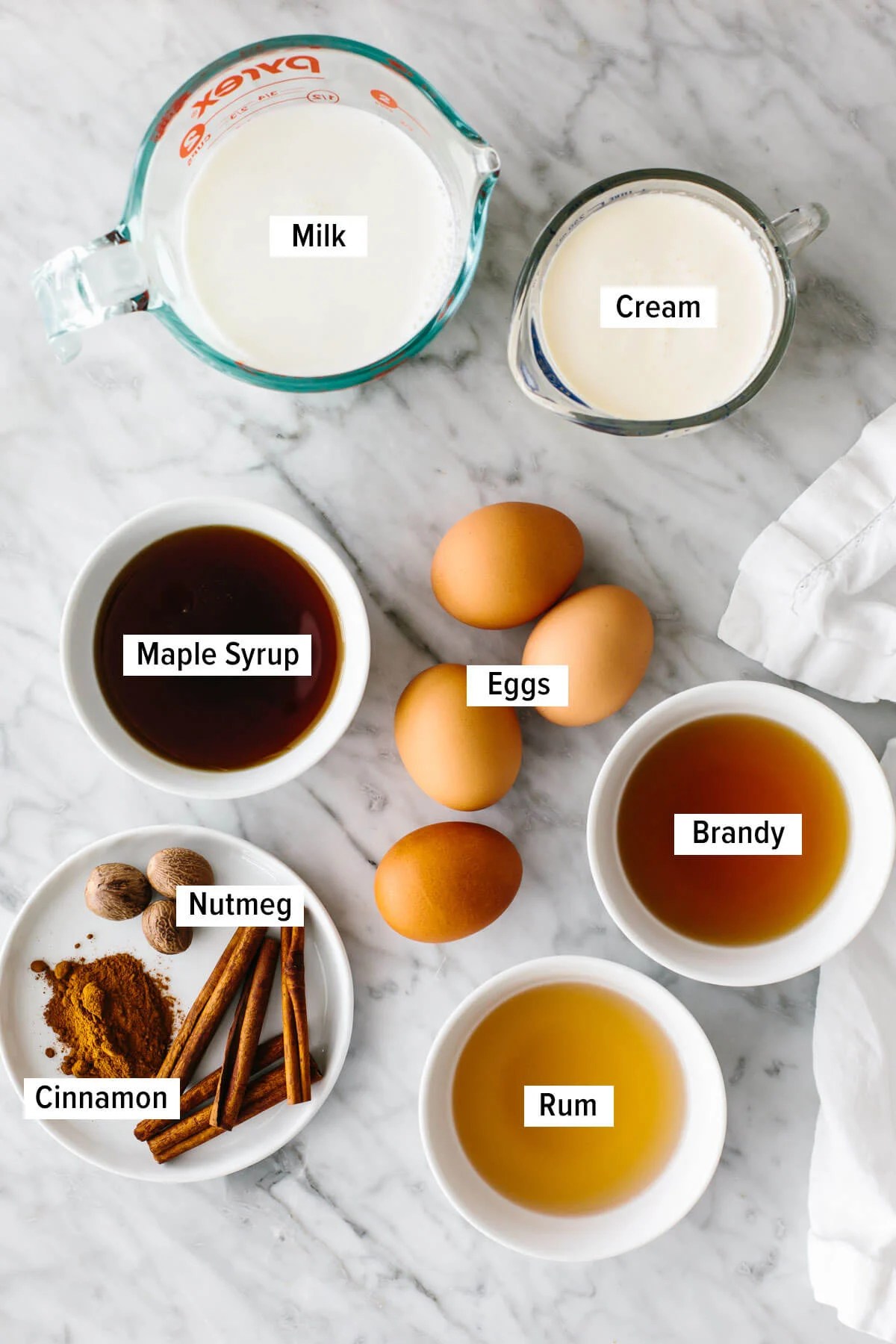 Homemade eggnog ingredients on a table.