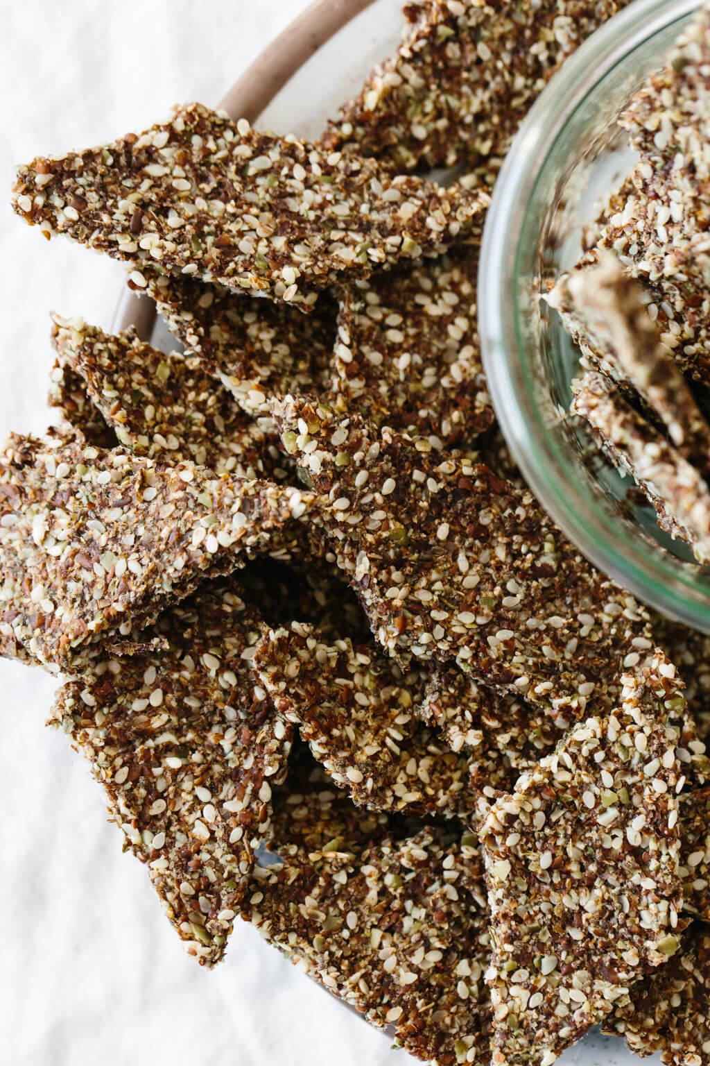 Flax seed crackers are a crunchy, flavorful, homemade cracker recipe that's naturally gluten-free, grain-free, nut-free, paleo and vegan. Made from flax seeds, chia seeds, sesame seeds and pumpkin seeds, they're super easy to make and great for snacking.