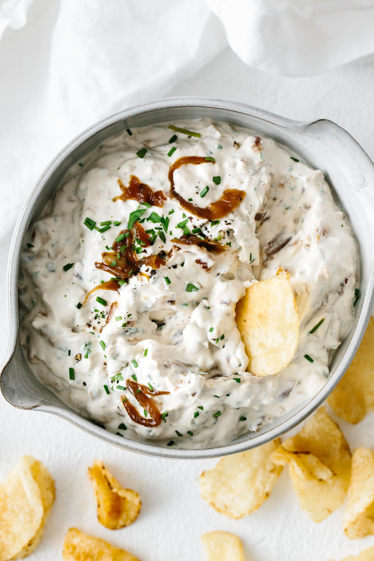 French onion dip in a bowl with a chip