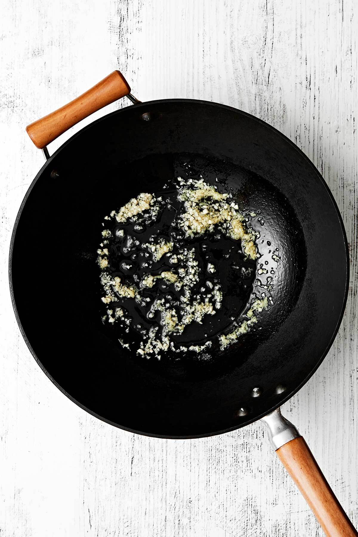 Cooking garlic and ginger in a wok.