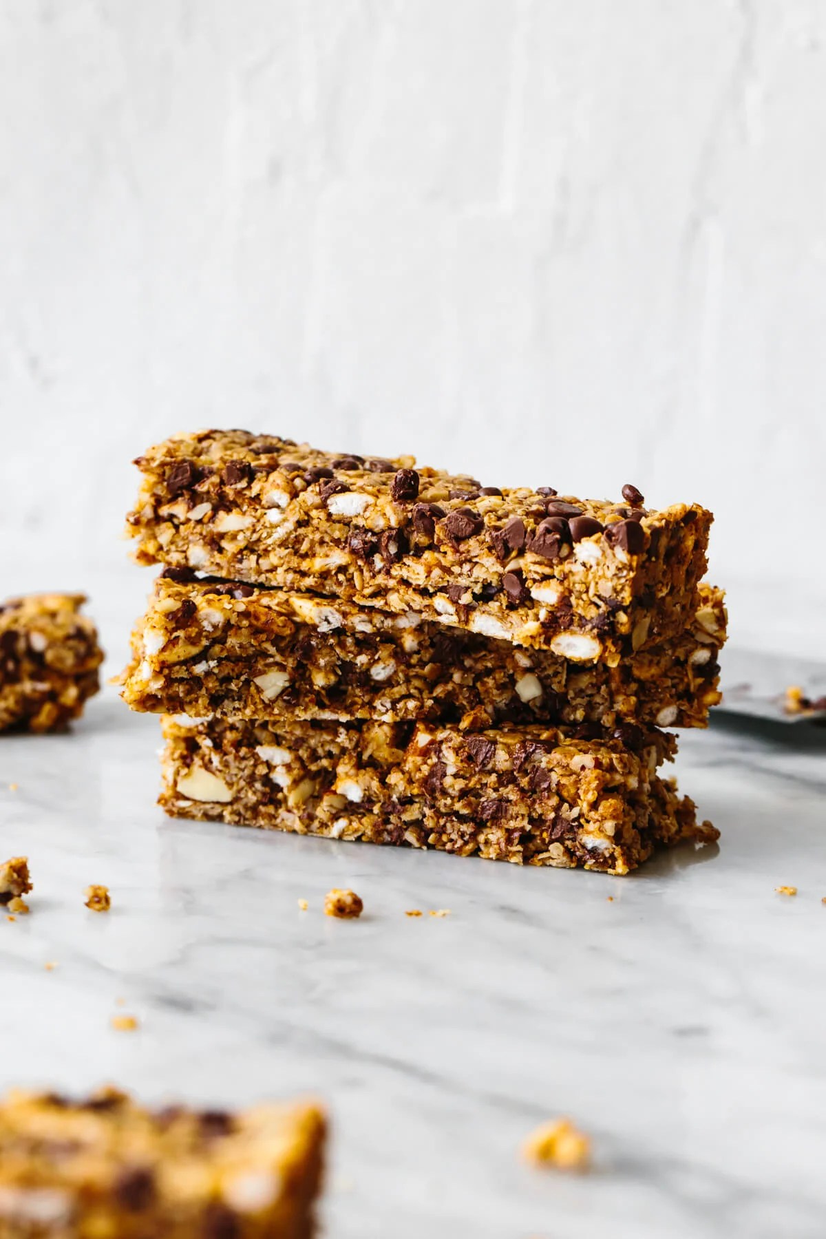 Chewy chocolate granola bars stacked on a table