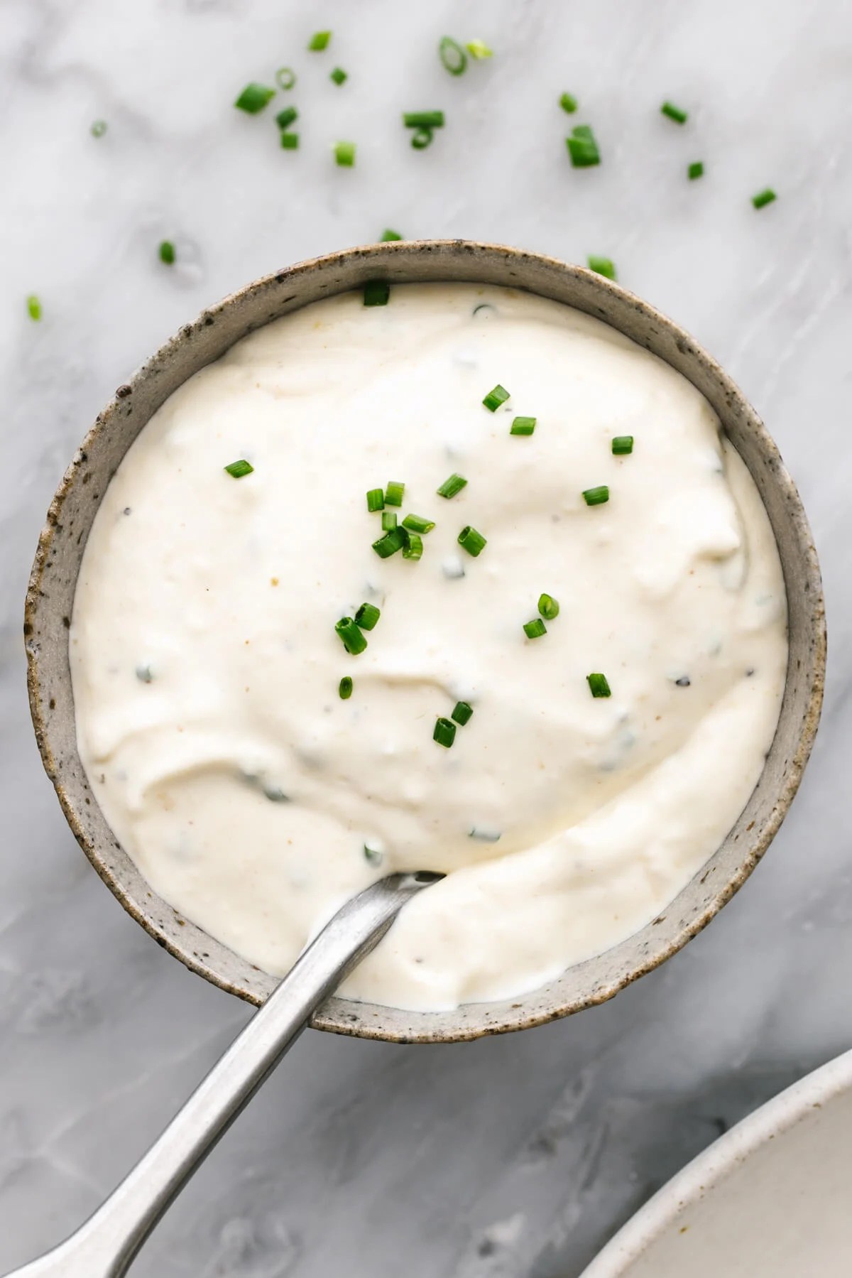 Horseradish sauce in a small bowl with a spoon