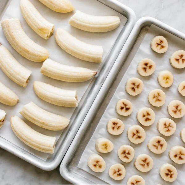 Two trays of frozen banana pieces