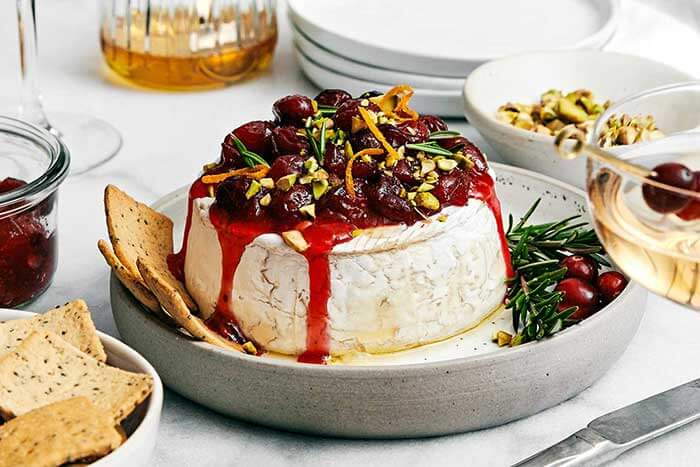 Baked brie with cranberry sauce and pistachios.