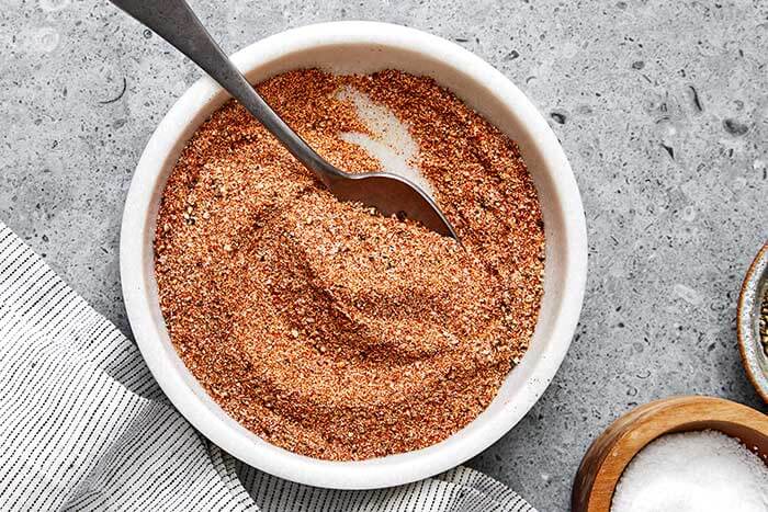 Mixed brisket rub with a spoon.