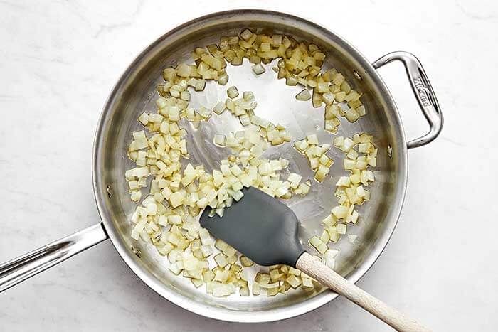 Cooking onions in a saute pan.