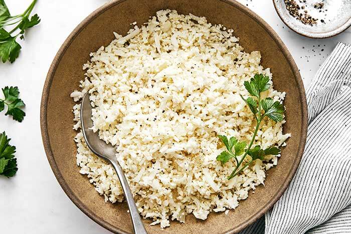 Cooked cauliflower rice in a bowl.