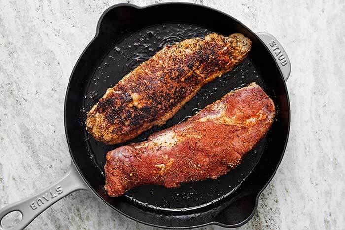 Searing pork tenderloin in a pan.