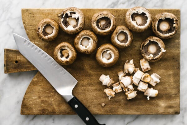 Mushrooms on a wooden board for stuffed mushrooms.