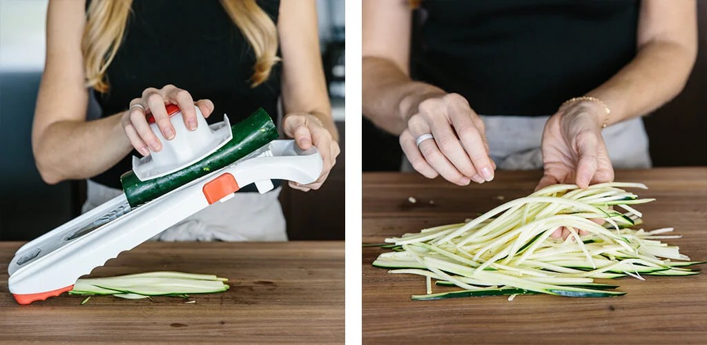 Making zucchini noodles with a mandoline.