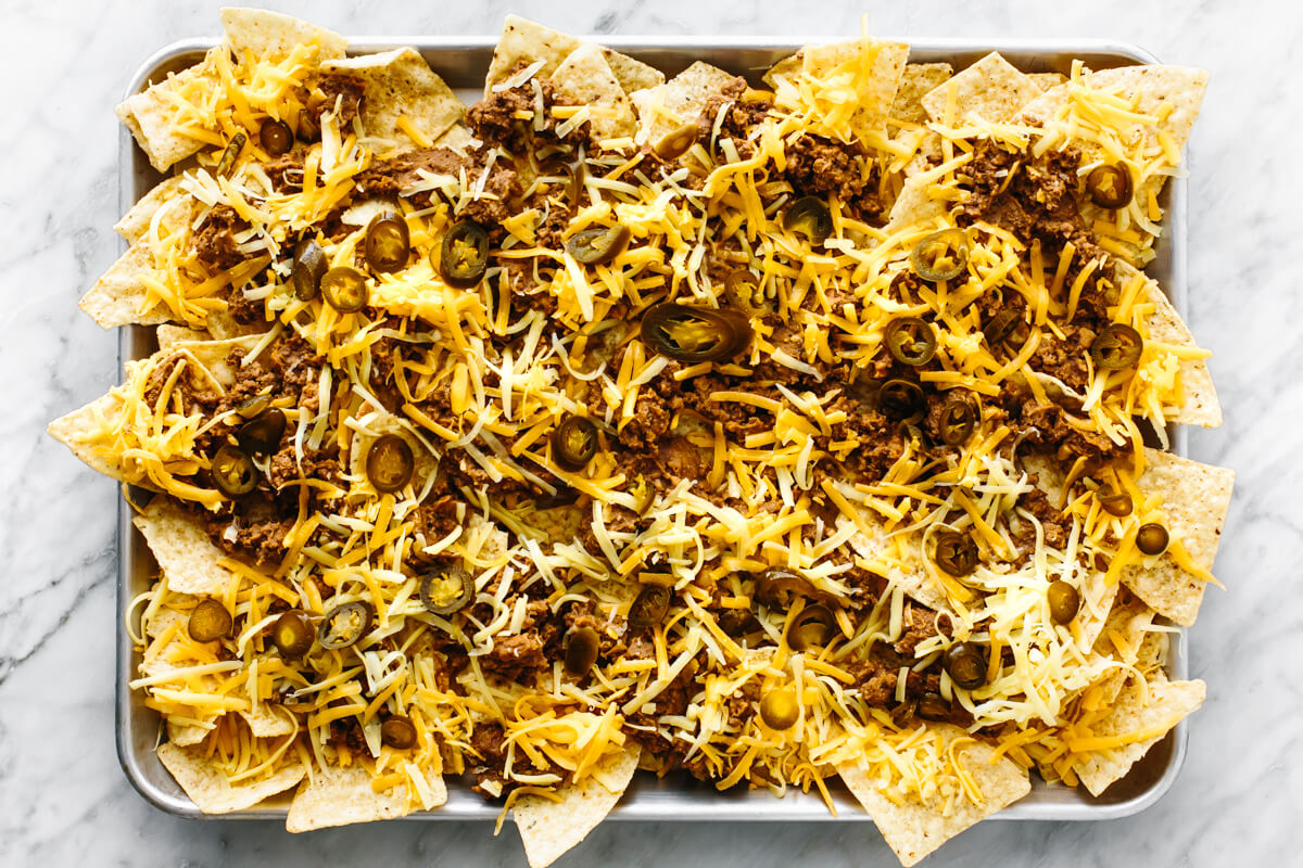 Layering nachos on a sheet pan