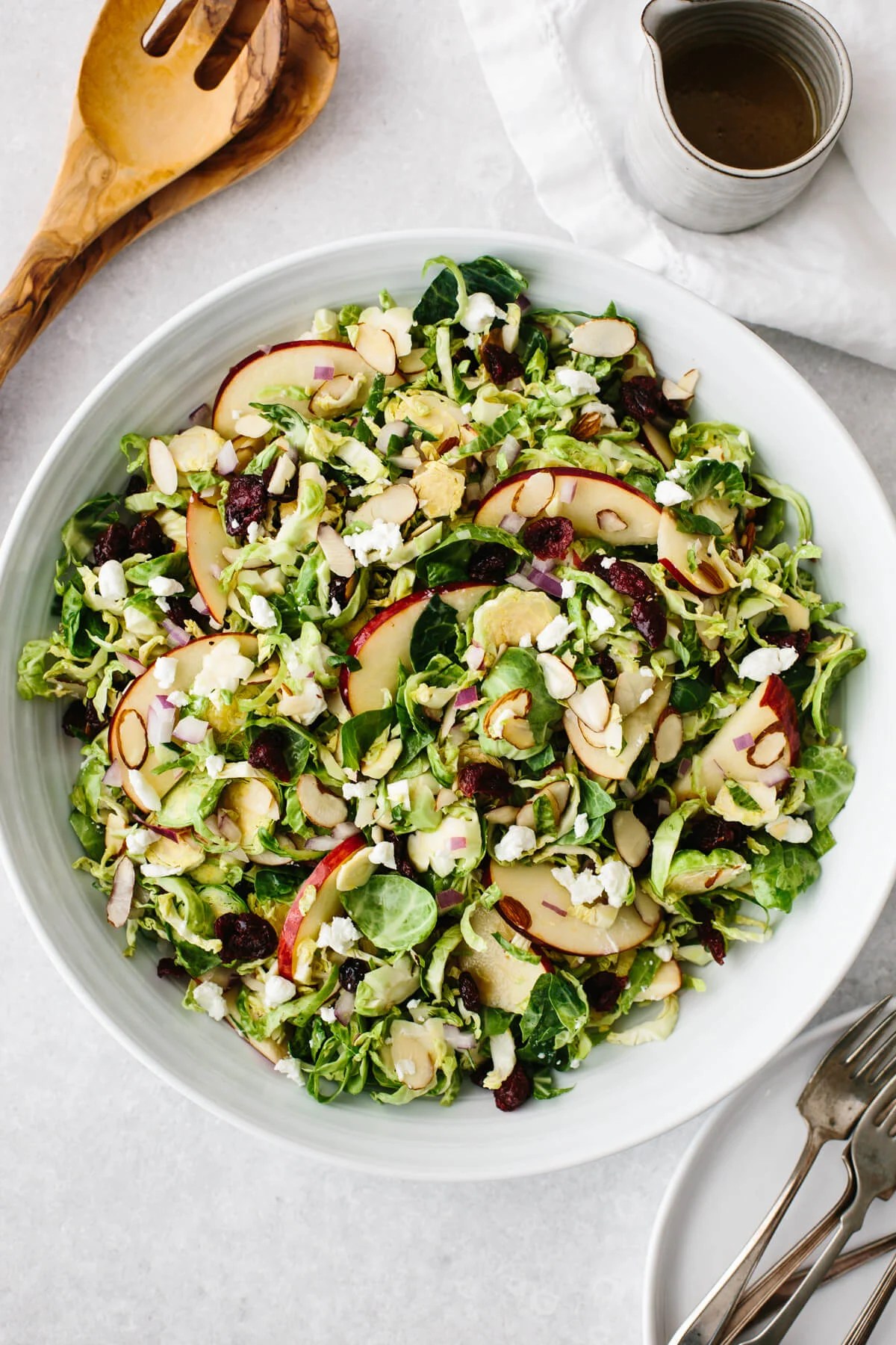 Shaved Brussels sprouts salad in a white bowl.