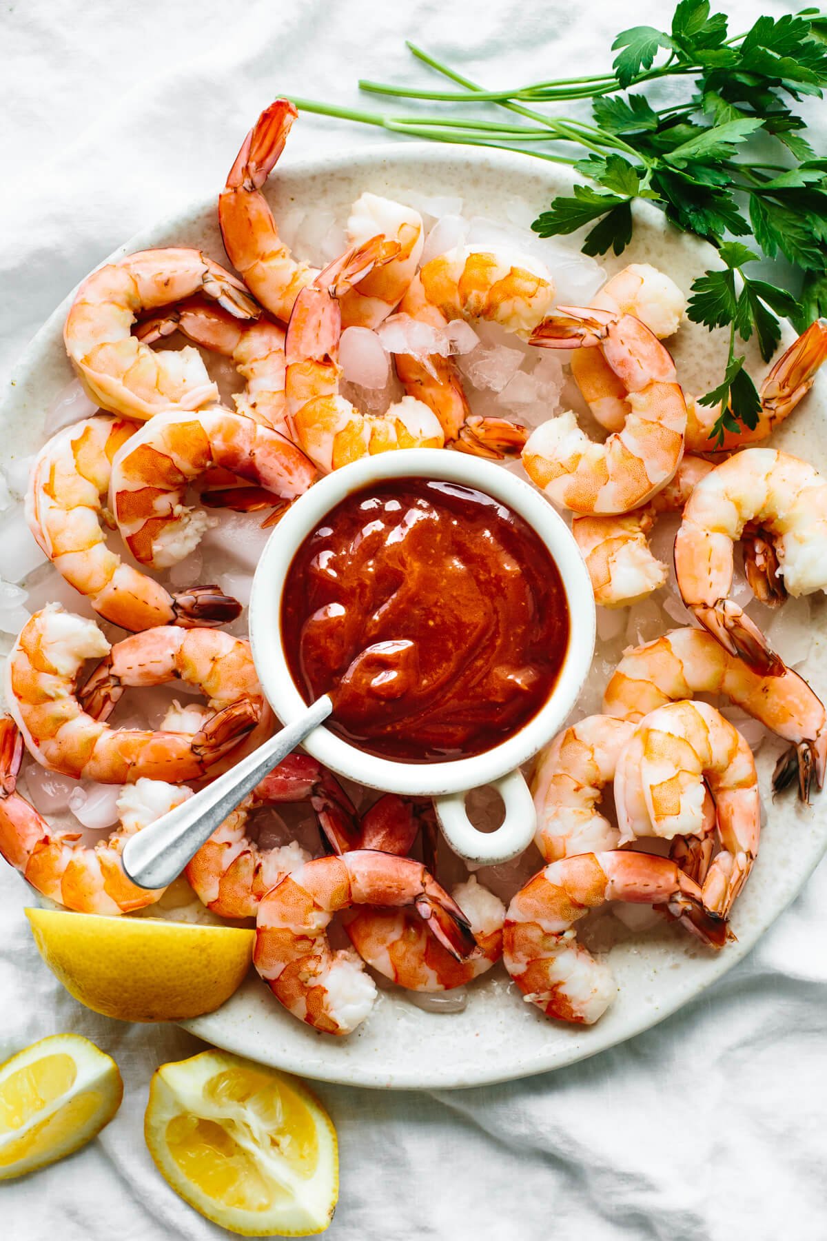 Shrimp cocktail on a platter with sauce.