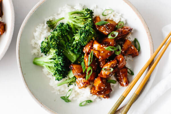 Teriyaki chicken in a bowl with rice and broccoli.