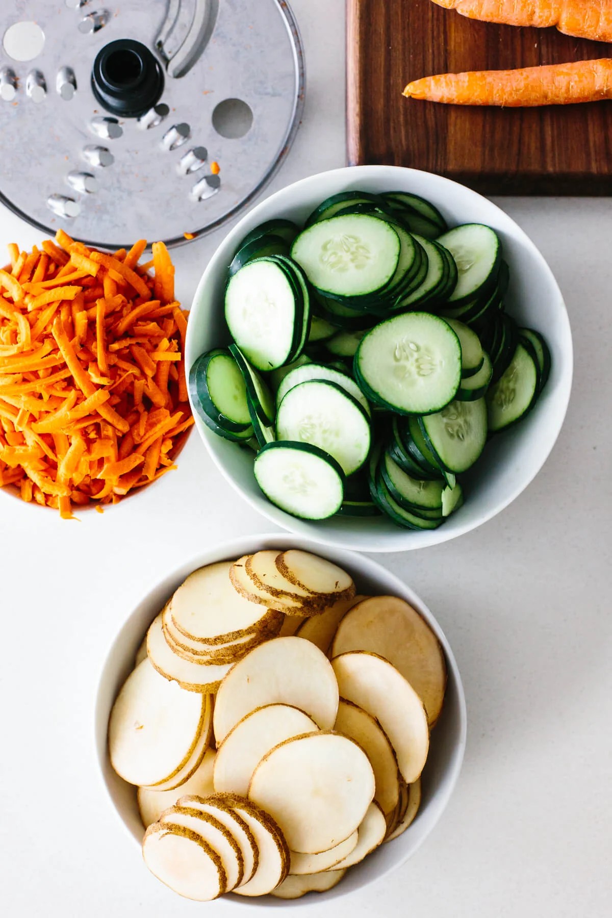 Bowls of sliced and shredded vegetables.