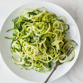 Zucchini noodles on a white plate.